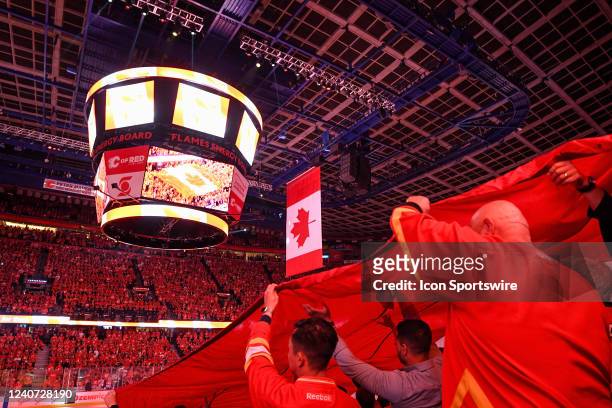 Giant Canadian flag is pulled across fans during the national anthems of game 7 of the first round of the NHL Stanley Cup Playoffs between the...