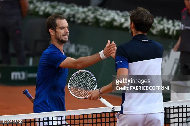 France's Richard Gasquet shakes hands with Russia's Daniil Medvedev after winning at the end of their ATP 250 Geneva Open tennis match in Geneva on...