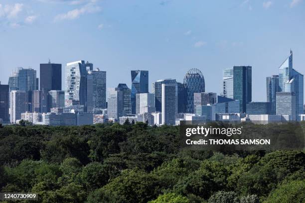 This picture taken in Paris on May 17, 2022 shows the skyline of La Defense business district and the Bois de Boulogne garden.