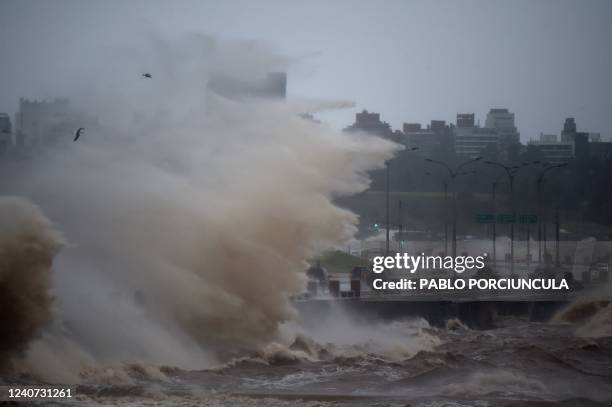 Waves crash over Montevideo's Rambla during the passage of a subtropical cyclone on May 17, 2022.