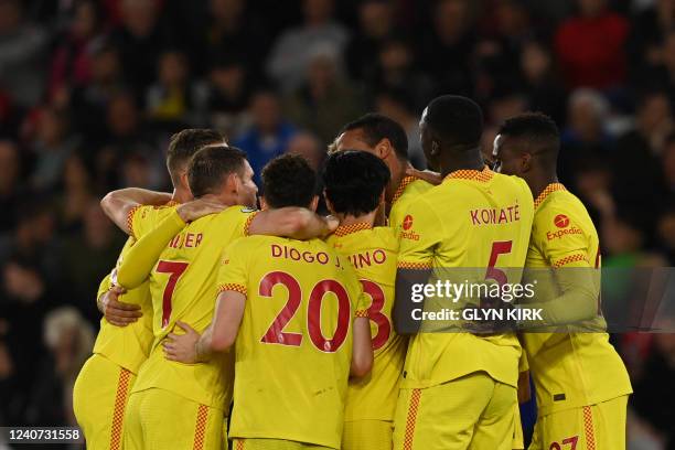 Liverpool's German-born Cameroonian defender Joel Matip celebrates with teammates after scoring his team second goal during the English Premier...