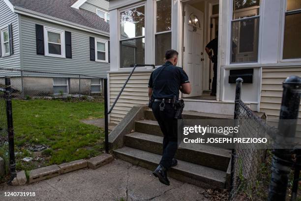 Officer Jose Rodriguez enters a house for a domestic call where a mother wanted her son evicted, in Chelsea, Massachusetts, on May 13, 2022. -...