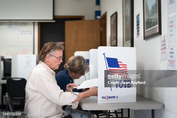 Man fills out a ballot at a voting booth on May 17, 2022 in Mt. Gilead, North Carolina. North Carolina is one of several states holding midterm...