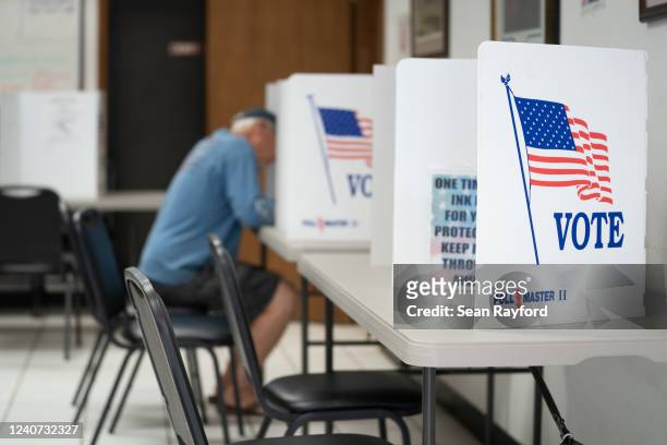 Man fills out a ballot at a voting booth on May 17, 2022 in Mt. Gilead, North Carolina. North Carolina is one of several states holding midterm...
