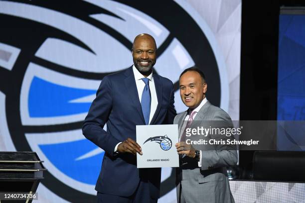 Deputy Commissioner of the NBA, Mark Tatum and Head Coach Jamahl Mosley of the Orland Magic hold up the card of the Orlando Magic after they get the...