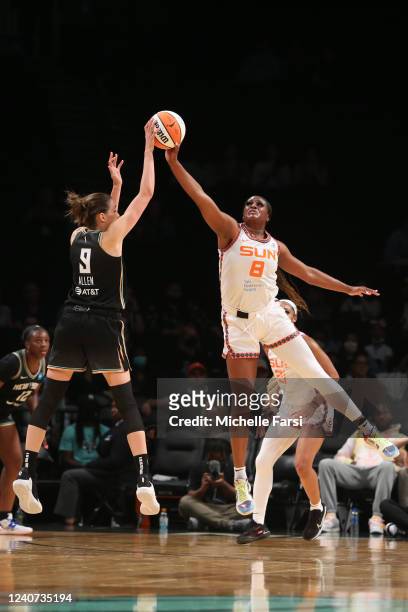 Joyner Holmes f the Connecticut Sun blocks a shot by Rebecca Allen of the New York Liberty during the game on May 17, 2022 at at Barclays Center in...
