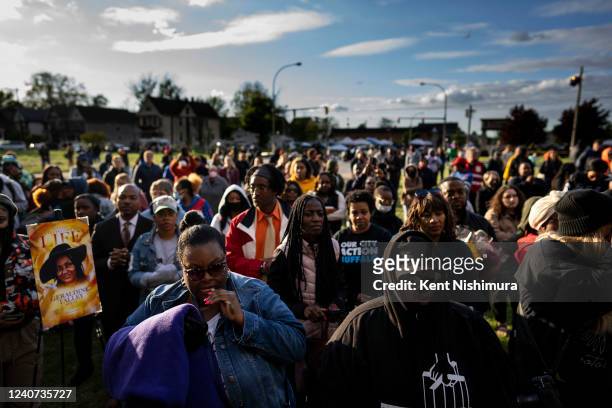 People attend a vigil across the street from Tops Friendly Market at Jefferson Avenue and Riley Street on Tuesday, May 17, 2022 in Buffalo, NY. The...
