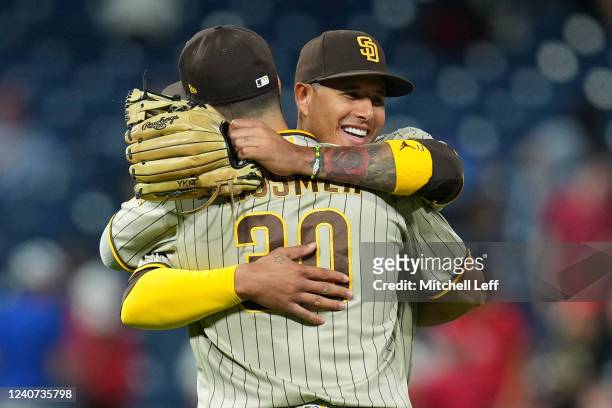 Eric Hosmer of the San Diego Padres hugs Manny Machado after the game against the Philadelphia Phillies at Citizens Bank Park on May 17, 2022 in...