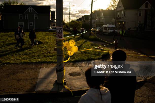 People walk near the intersection of Jefferson Avenue and Riley Street attend a vigil across the street from Tops Friendly Market on Tuesday, May 17,...