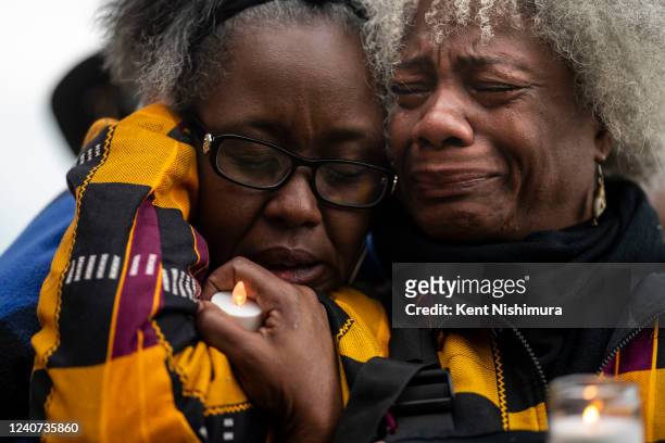 Janate Ingram, of Buffalo, comforts Cariol Horne, of Buffalo, as they attend a vigil across the street from Tops Friendly Market at Jefferson Avenue...