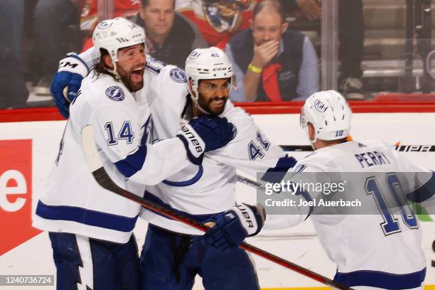 Pierre-Edouard Bellemare of the Tampa Bay Lightning celebrates his goal with Pat Maroon and Corey Perry in the third period against the Florida...