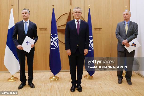 LtoR, Finland's Ambassador to NATO Klaus Korhonen, NATO Secretary-General Jens Stoltenberg and Sweden's Ambassador to NATO Axel Wernhoff pose during...