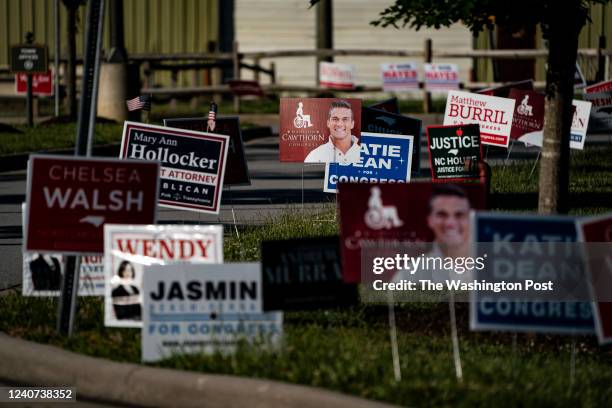 May 17 : Signs for Rep. Madison Cawthorn, R-N.C., and others are seen outside the Fletcher Town Hall polling location for the North Carolina primary...