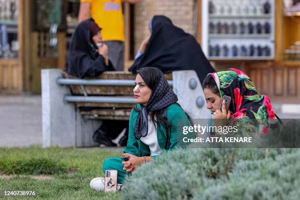 Woman sits in the garden at the historic Naqsh-e Jahan Square in Iran's central city of Isfahan on May 17, 2022.