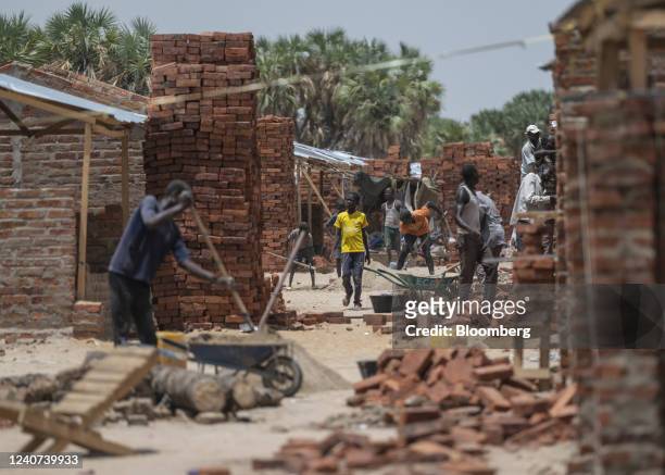 Workers mix cement on a construction site for residential houses in a suburb of N'Djamena, Chad, on Monday, May 10, 2022. Last year, Chad became the...