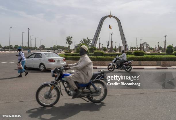 Morning commuters pass the Place de La Nation monument in N'Djamena, Chad, on Tuesday, May 10, 2022. Last year, Chad became the first country to...