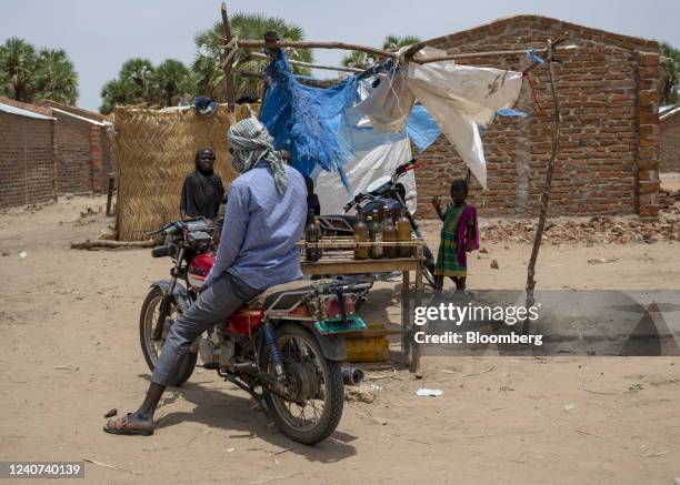 Motorcyclist purchases petrol from an informal street seller on the roadside in a suburb of N'Djamena, Chad, on Monday, May 10, 2022. Last year, Chad...