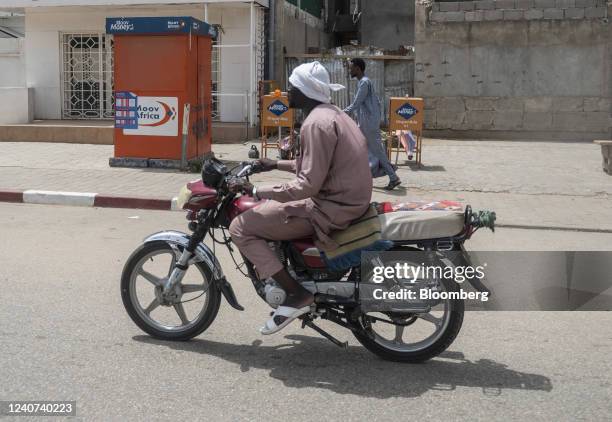 Motorcyclist drives past a closed Moov Africa BV mobile money stand in N'Djamena, Chad, on Friday, May 13, 2022. Last year, Chad became the first...