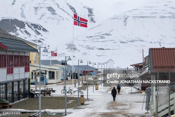 The Norwegian flag flutters on the roadside of Longyearbyen's main street, on May 9 on Spitsbergen island, in Svalbard Archipelago, northern Norway.