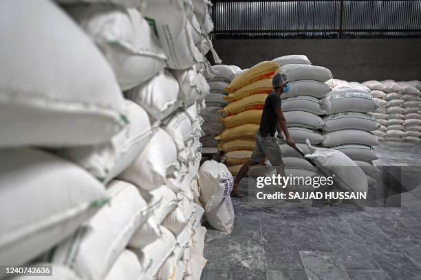 Labourer works inside a mill of refined wheat flour at Khanna in India's Punjab state on May 18, 2022. - The United States hopes that India will...