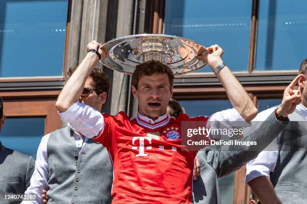 Thomas Mueller of Bayern Muenchen celebrates with the trophy during the official Bundesliga championship celebration at Marienplatz on May 15, 2022...