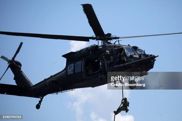 Special operations soldier deploy from a UH-60 Blackhawk helicopter, piloted by the U.S. Army's 160th Special Operations Aviation Regiment , during...