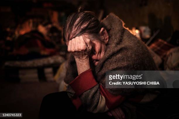 Klaudia Pushnir takes refuge in the basement of an apartment during ongoing mortar shell explosions in Severodonetsk, eastern Ukraine, on May 18 on...