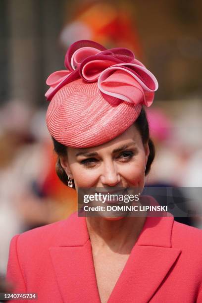 Britain's Catherine, Duchess of Cambridge speaks to guests at a Royal Garden Party at Buckingham Palace in London on May 18, 2022.