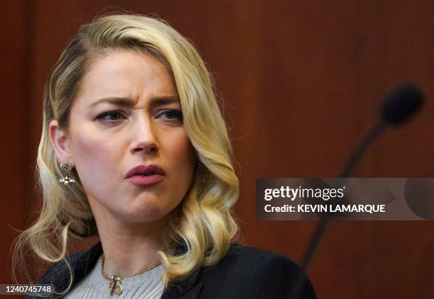 Amber Heard watches Raquel Pennington testify in a previously recorded video deposition during Johnny Depp's defamation trial against his ex-wife...