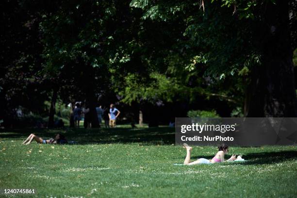 People enjoy the sun in a park. The very same day where Antonio Gutierrez, UN secretary, issues a dark warning about climate change and 'climate...