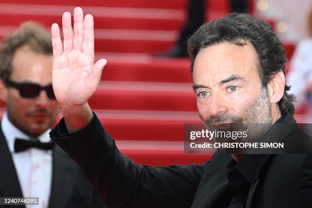 French actor Anthony Delon waves as he arrives for the screening of the film "Top Gun : Maverick" during the 75th edition of the Cannes Film Festival...