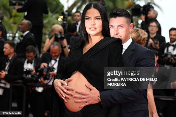 Brazilian model Adriana Lima and US film producer Andre Lemmers arrive for the screening of the film "Top Gun : Maverick" during the 75th edition of...