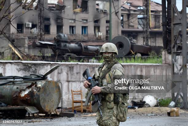 Russian serviceman stands guard at the destroyed part of the Ilyich Iron and Steel Works in Ukraine's port city of Mariupol on May 18 amid the...