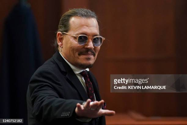 Actor Johnny Depp waves as he leaves the courtroom at the end of today's hearings in his defamation trial against ex-wife Amber Heard at the Fairfax...