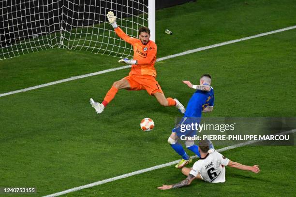 Rangers' English midfielder Ryan Kent shoots and fails to score as Frankfurt's German goalkeeper Kevin Trapp prepares to make a save during the UEFA...