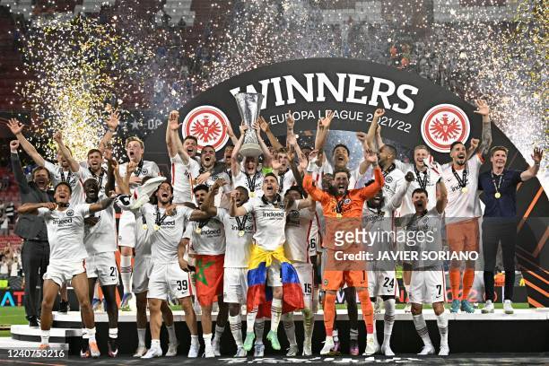 Eintracht Frankfurt's German midfielder and captain Sebastian Rode lifts the trophy as Eintracht Frankfurt players celebrate after winning the UEFA...
