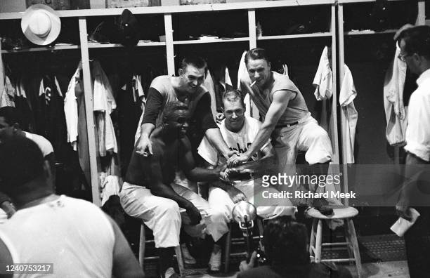 Brooklyn Dodgers Jackie Robinson in the locker room posing with teammates after game vs St. Louis Cardinals at Ebbets Field. Brooklyn, NY 8/3/1956...