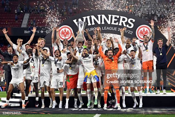 Eintracht Frankfurt's German midfielder and captain Sebastian Rode lifts the trophy as Eintracht Frankfurt players celebrate after winning the UEFA...