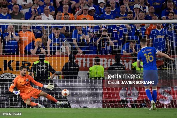 Frankfurt's German goalkeeper Kevin Trapp stops the ball shot from Rangers' Welsh midfielder Aaron Ramsey during the penalty shootout during the UEFA...