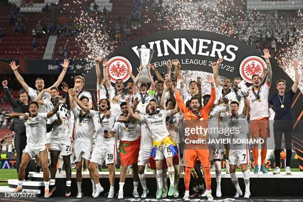 Eintracht Frankfurt's German midfielder and captain Sebastian Rode lifts the trophy as Eintracht Frankfurt players celebrate after winning the UEFA...