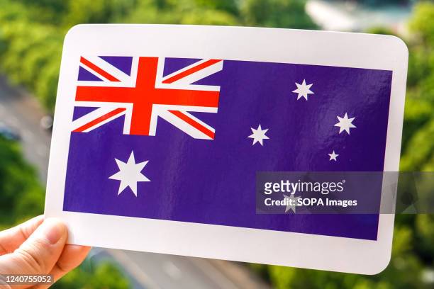 In this photo illustration, the Australian flag is printed on a white card.