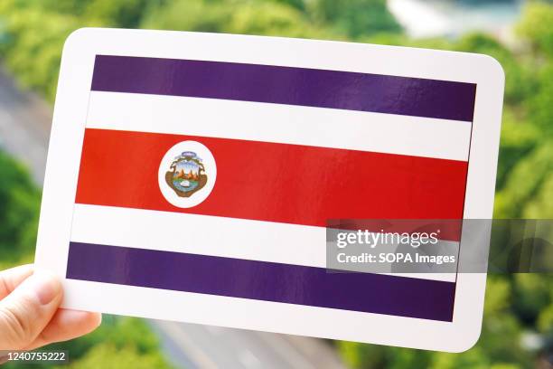 In this photo illustration, the flag of Costa Rica is printed on a white card.