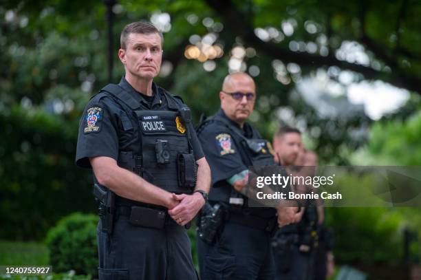 Police officers stand outside the home of U.S. Supreme Court Justice Brett Kavanaugh in anticipation of an abortion-rights demonstration on May 18,...