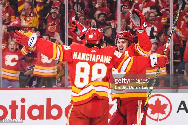 Andrew Mangiapane of the Calgary Flames celebrates with teammate Mikael Backlund after scoring against the Edmonton Oilers during the first period of...
