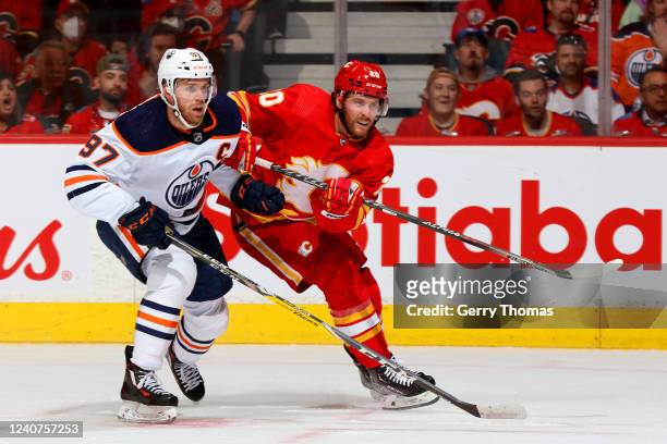 Blake Coleman of the Calgary Flames skates against Connor McDavid of the Edmonton Oilers in Game One of the Second Round of the 2022 Stanley Cup...