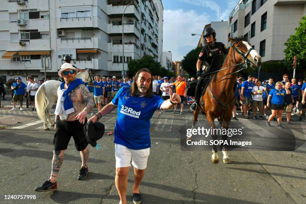 Mounted police officer rides past the Glasgow Rangers fans outside the Ramón Sánchez-Pizjuán Stadium. Prior to the Europa League final match between...