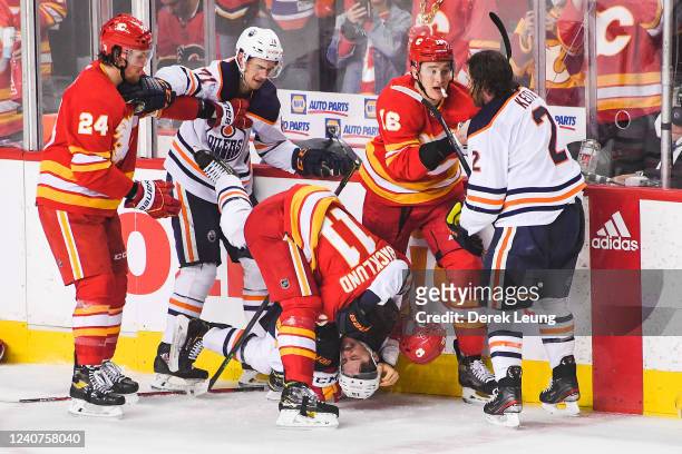 Mikael Backlund of the Calgary Flames fights Josh Archibald of the Edmonton Oilers during the third period of Game One of the Second Round of the...