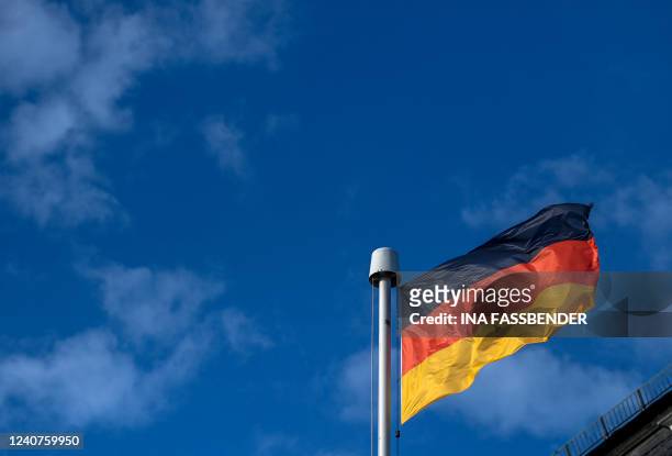 German flag waves at the building of the Petersberg before a meeting of finance ministers and central bankers from the Group of Seven industrialised...