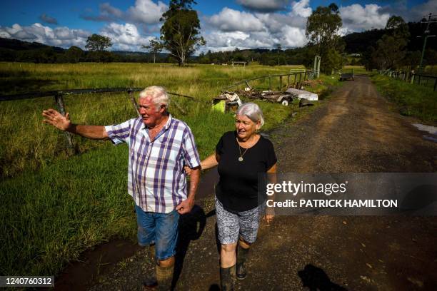 This photo taken on May 15 shows resident Ron Maher and his partner Meke Flanagan walking through Goolmangar farm as he recalls the devastation by...