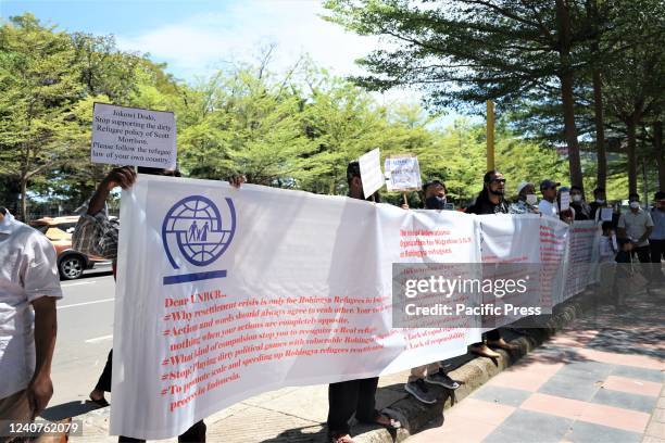 Hundreds of Rohingya refugees from Myanmar who have lived in Indonesia for a dozen years staged a protest by carrying banners in front of the UNHCR...